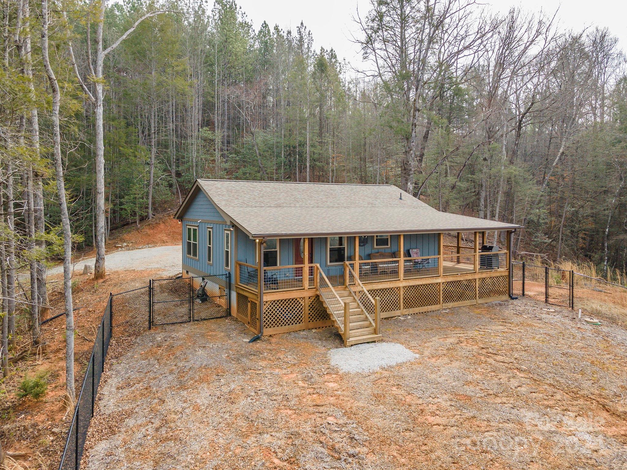 4125 Old Greenlee Road Marion, NC 28752 - Photo 1 of 48 an aerial view of a house with a yard and sitting area