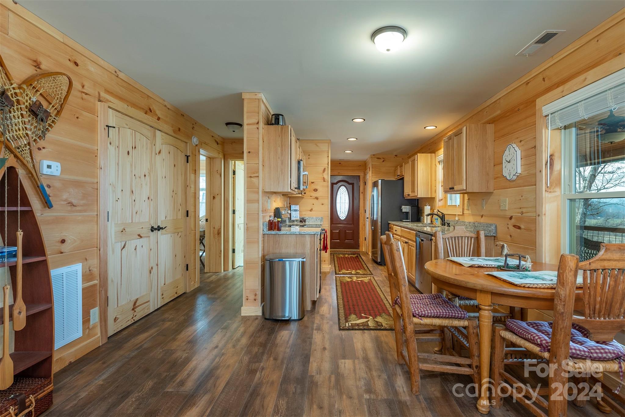4125 Old Greenlee Road Marion, NC 28752 - Photo 14 of 48 a dining room with stainless steel appliances kitchen island granite countertop a table chairs and a refrigerator