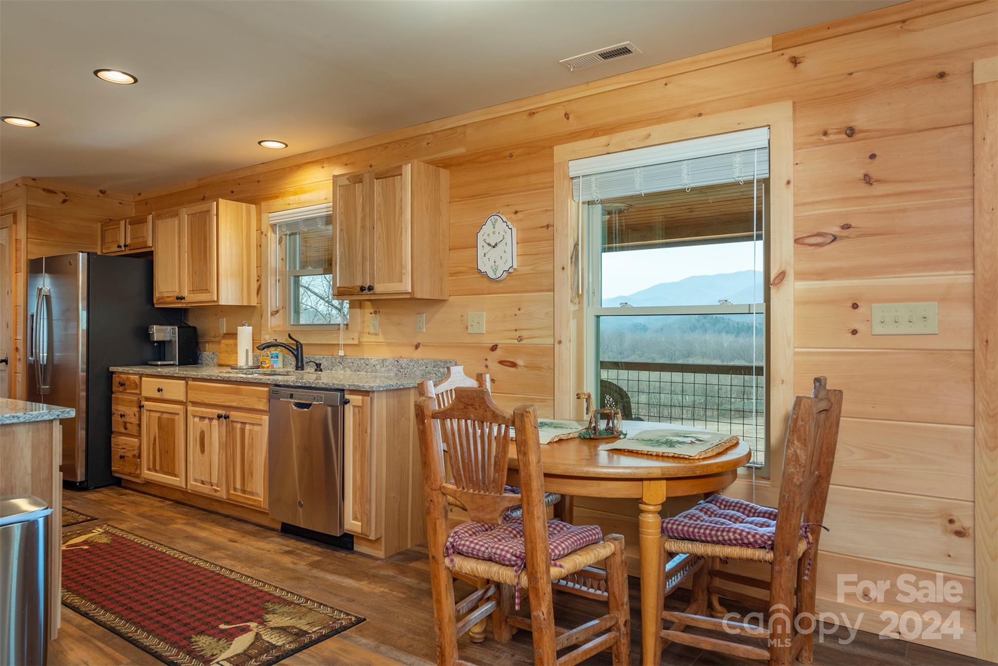 4125 Old Greenlee Road Marion, NC 28752 - Photo 15 of 48 a kitchen with a refrigerator and table chair