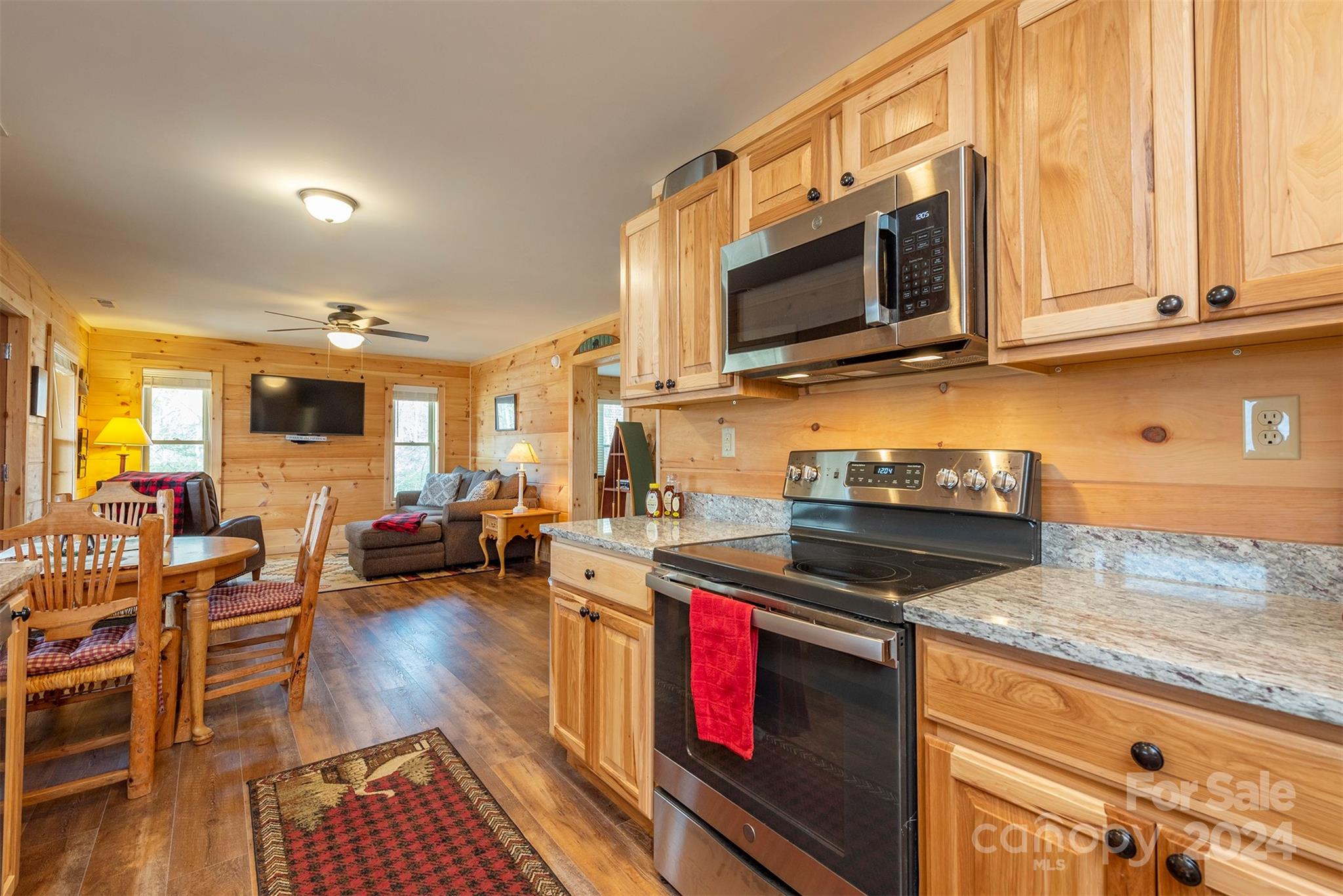 4125 Old Greenlee Road Marion, NC 28752 - Photo 17 of 48 a kitchen with stainless steel appliances granite countertop a stove and a wooden cabinets
