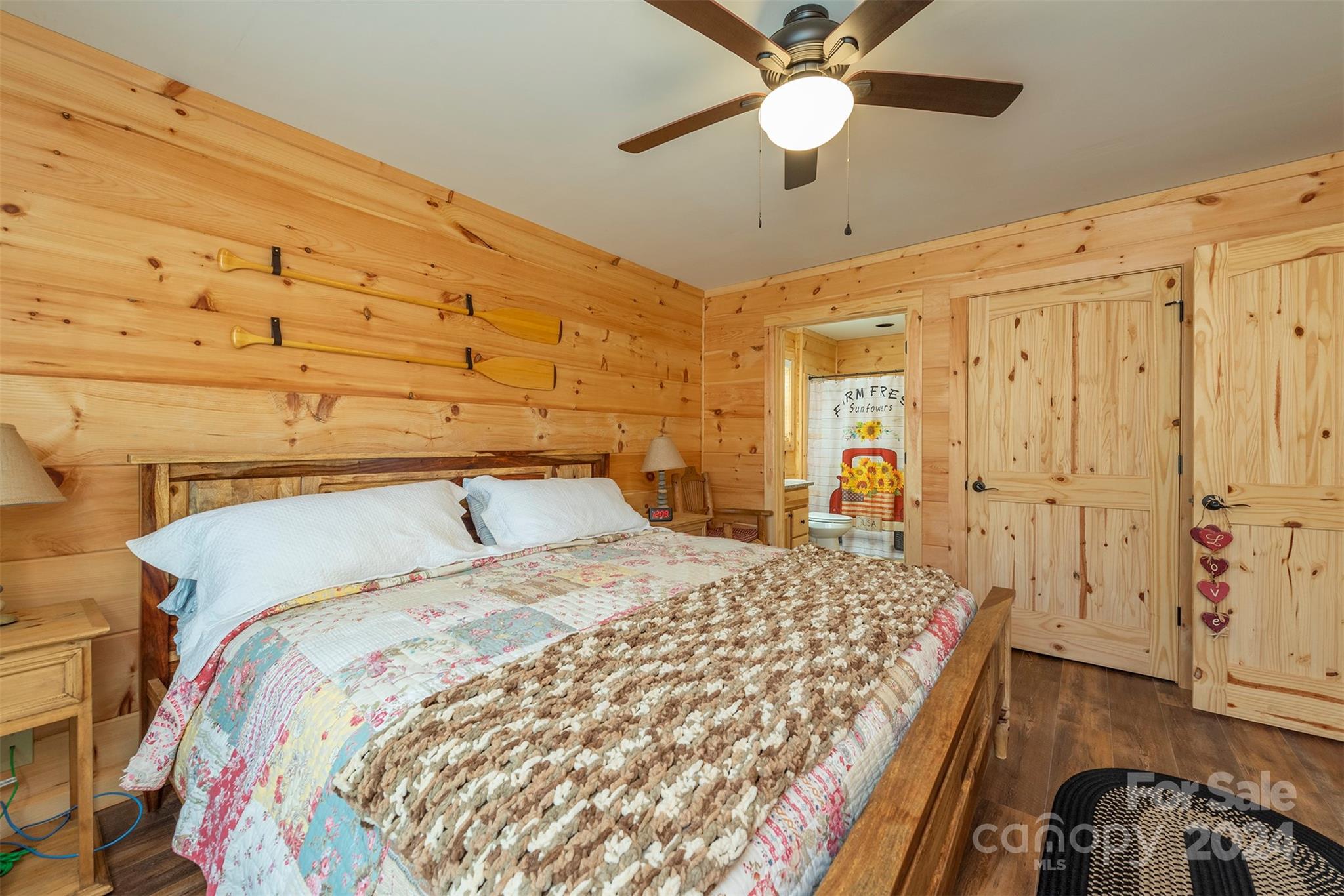4125 Old Greenlee Road Marion, NC 28752 - Photo 21 of 48 a bedroom with a bed and a chandelier