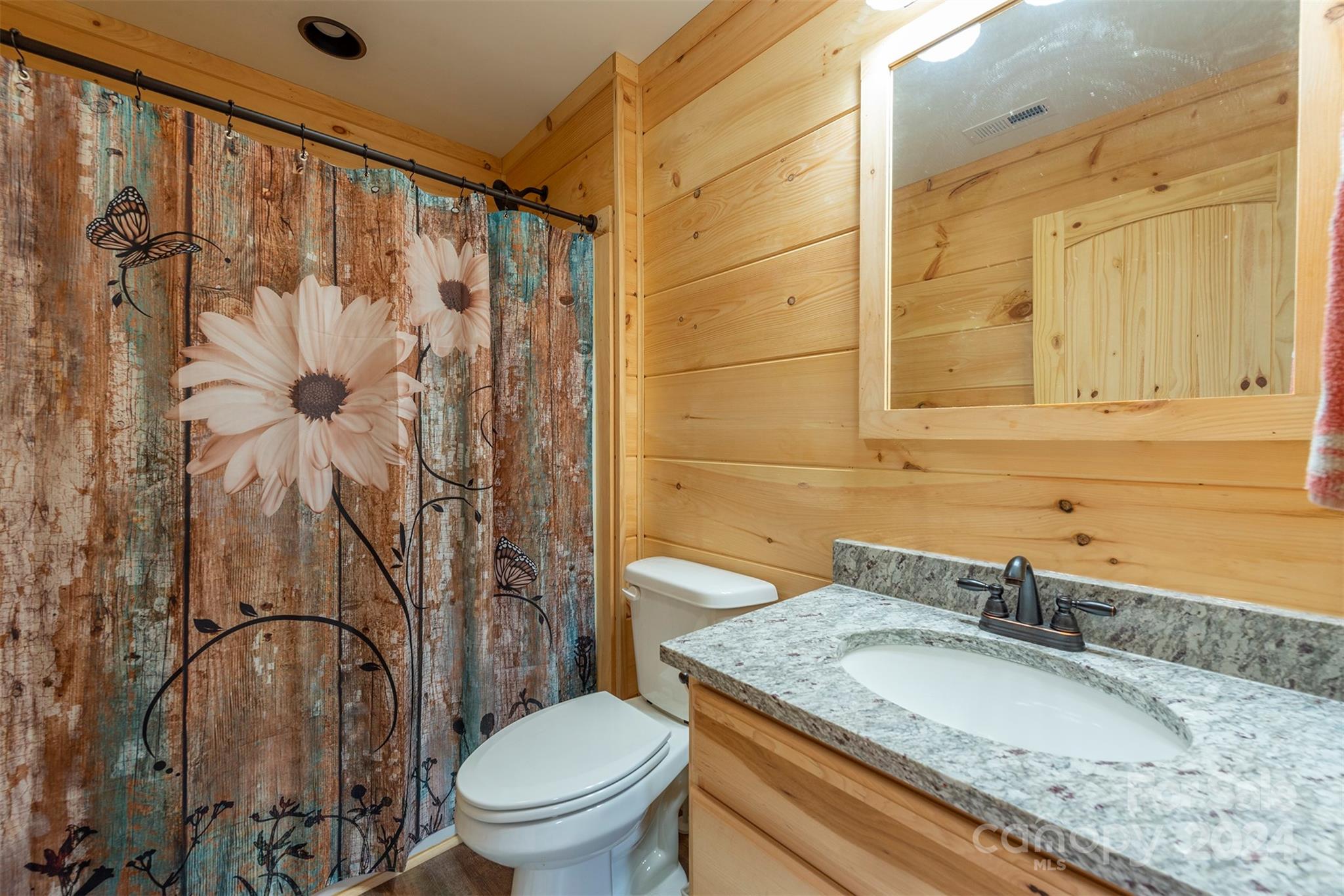 4125 Old Greenlee Road Marion, NC 28752 - Photo 23 of 48 a bathroom with a granite countertop sink toilet and shower