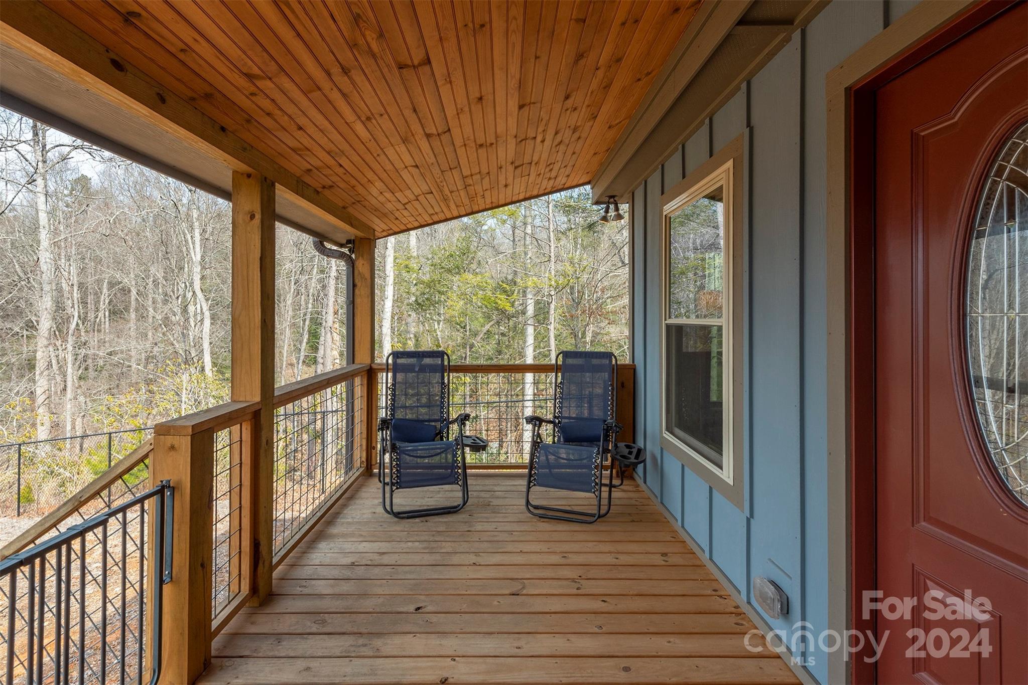 4125 Old Greenlee Road Marion, NC 28752 - Photo 9 of 48 a view of a balcony with chairs and wooden floor