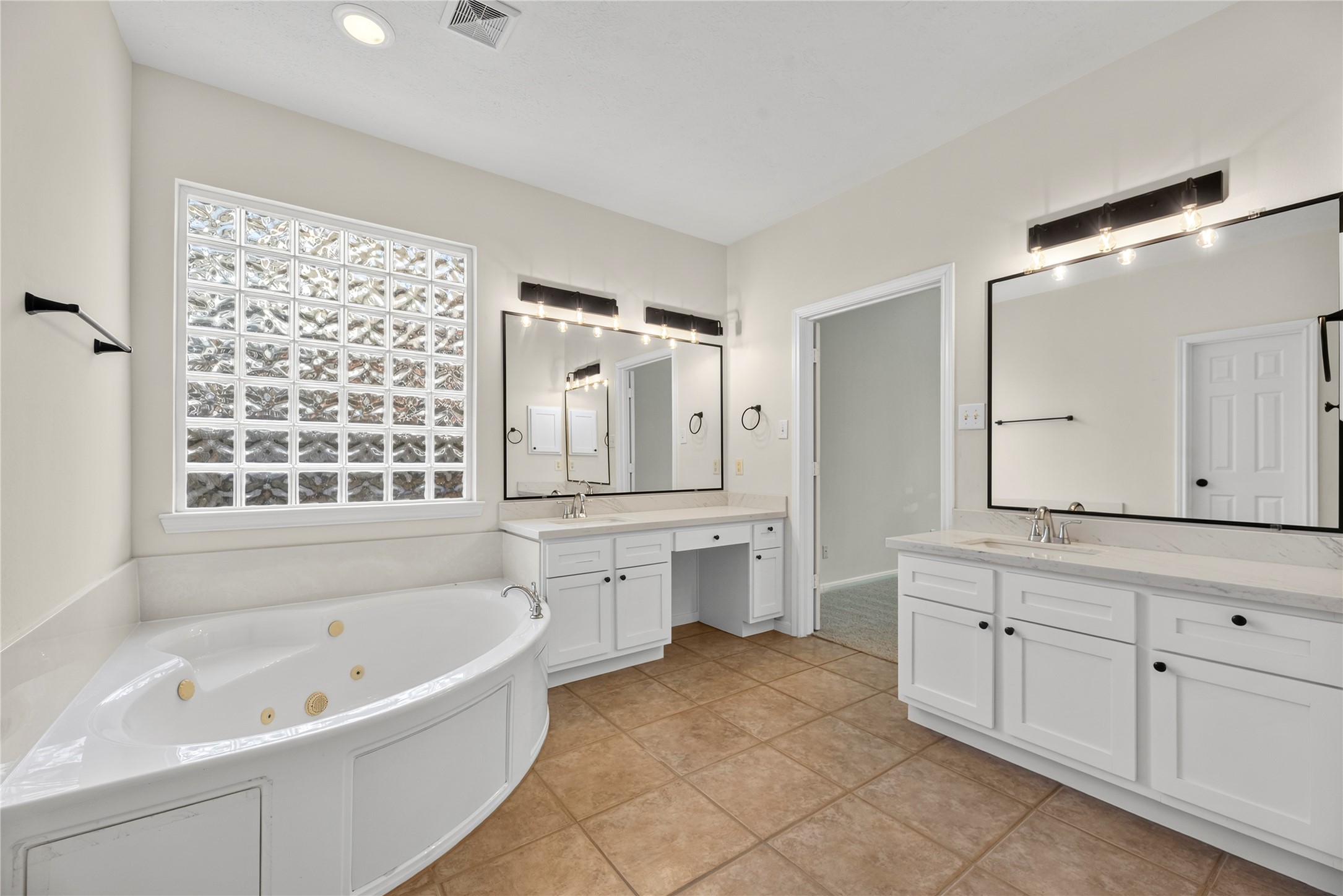25830 Clear Springs Way Spring, TX 77373 - Photo 15 of 25 Spa-like primary bathroom features dual vanities, jetted tub and separate shower.