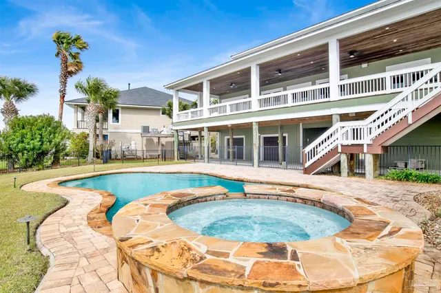 a view of an house with swimming pool and sitting area