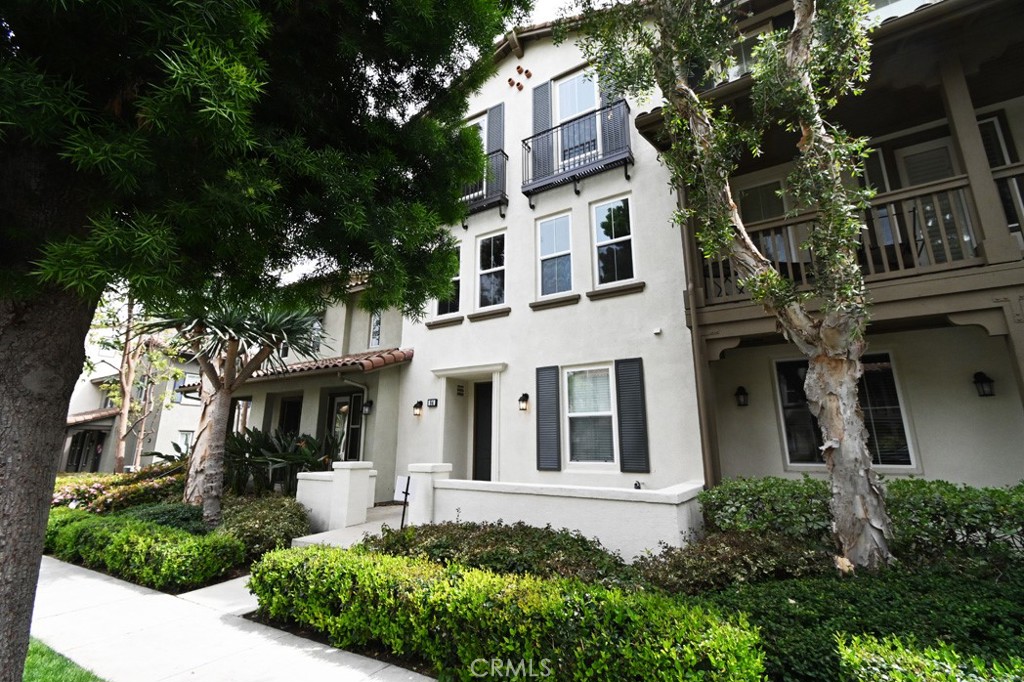 front view of a white house with a yard