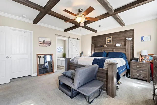 a bed room with a bed and a ceiling fan