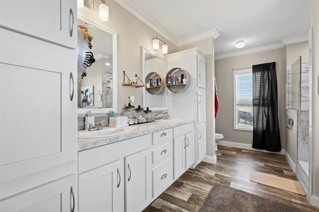 a bathroom with a sink a mirror and a shower