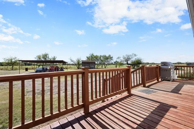 a balcony with wooden floor and fence