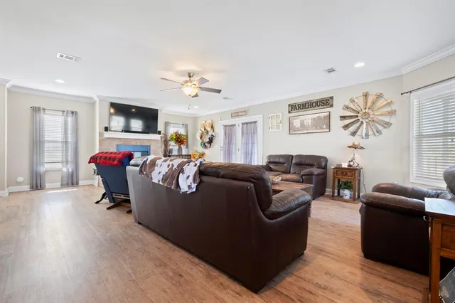 a living room with furniture window and a flat screen tv