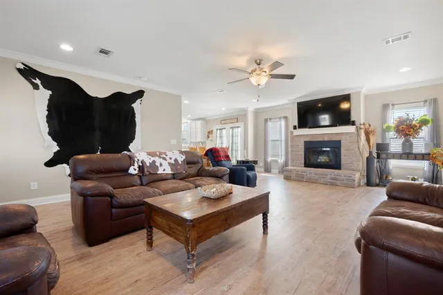 a living room with furniture a flat screen tv and a fireplace