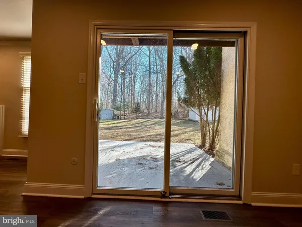 a view of a room with wooden floor