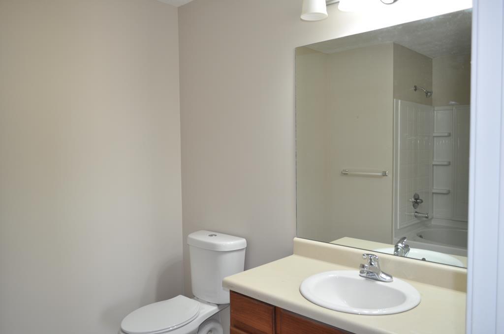 142 Old Indian Springs Road Forsyth, GA 31029 - Photo 12 of 30 a bathroom with a sink a toilet and a mirror