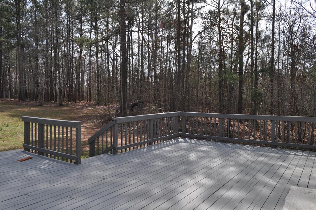 142 Old Indian Springs Road Forsyth, GA 31029 - Photo 30 of 30 a view of a deck with wooden fence and trees