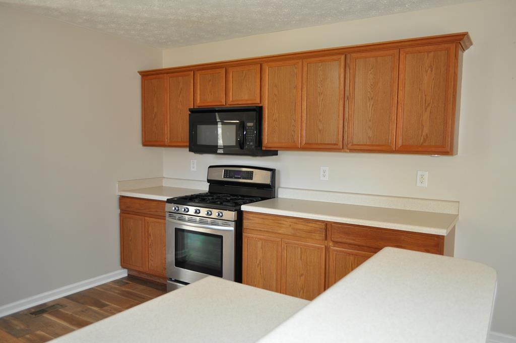 142 Old Indian Springs Road Forsyth, GA 31029 - Photo 5 of 30 a kitchen with a cabinets and appliances