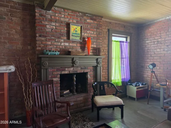 a living room with furniture gym equipment and a large window