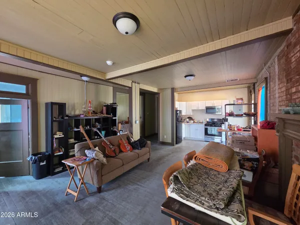a view of a hallway with wooden floor and stairs
