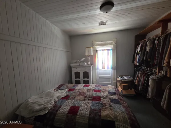 a bedroom with a bed and a window