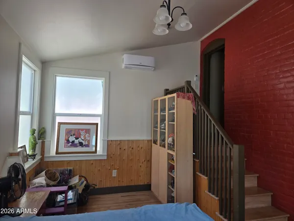 a view of a hallway with furniture and wooden floor