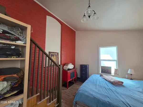 a view of a hallway with wooden floor and windows