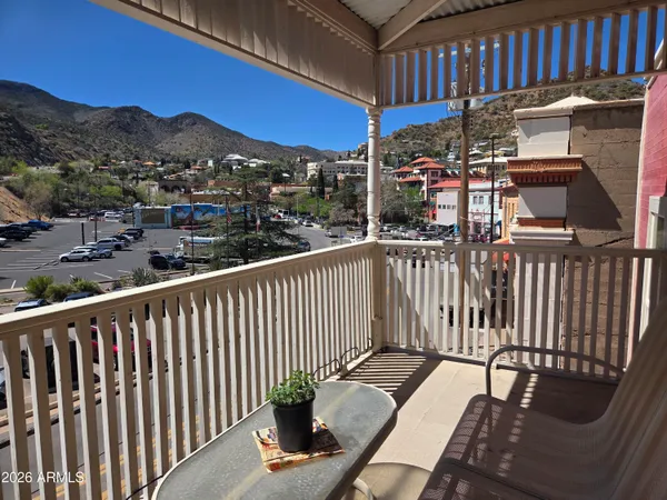 a view of staircase with railing and white walls