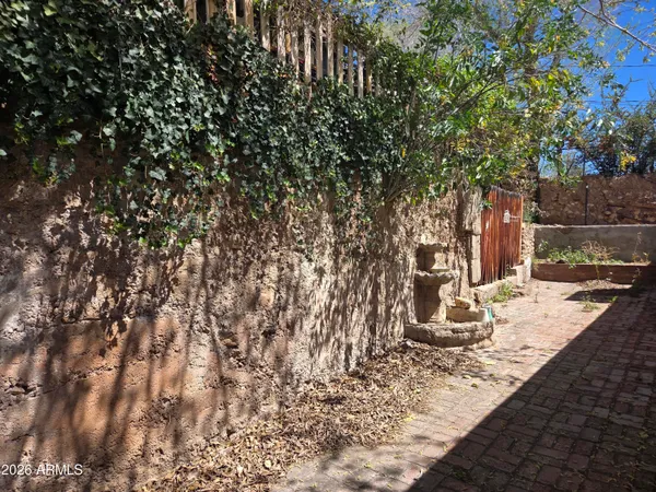 a view of a chair and table in the backyard