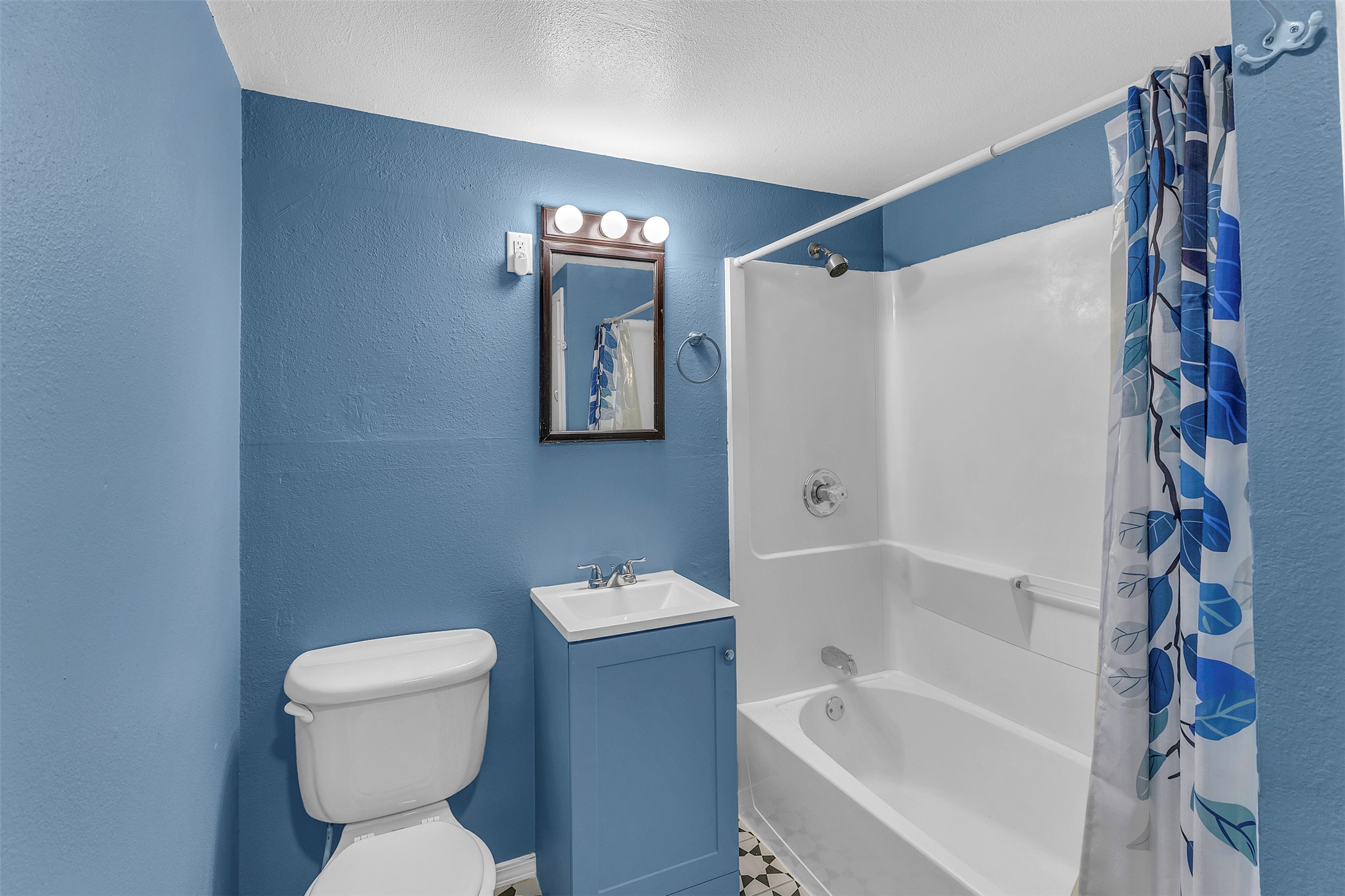 1002 Washburn Street Taylor, TX 76574 - Photo 16 of 29 Bathroom featuring a shower and bathtub combination, a vanity with a white sink, and a toilet