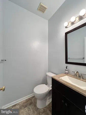 a bathroom with a sink a toilet and mirror