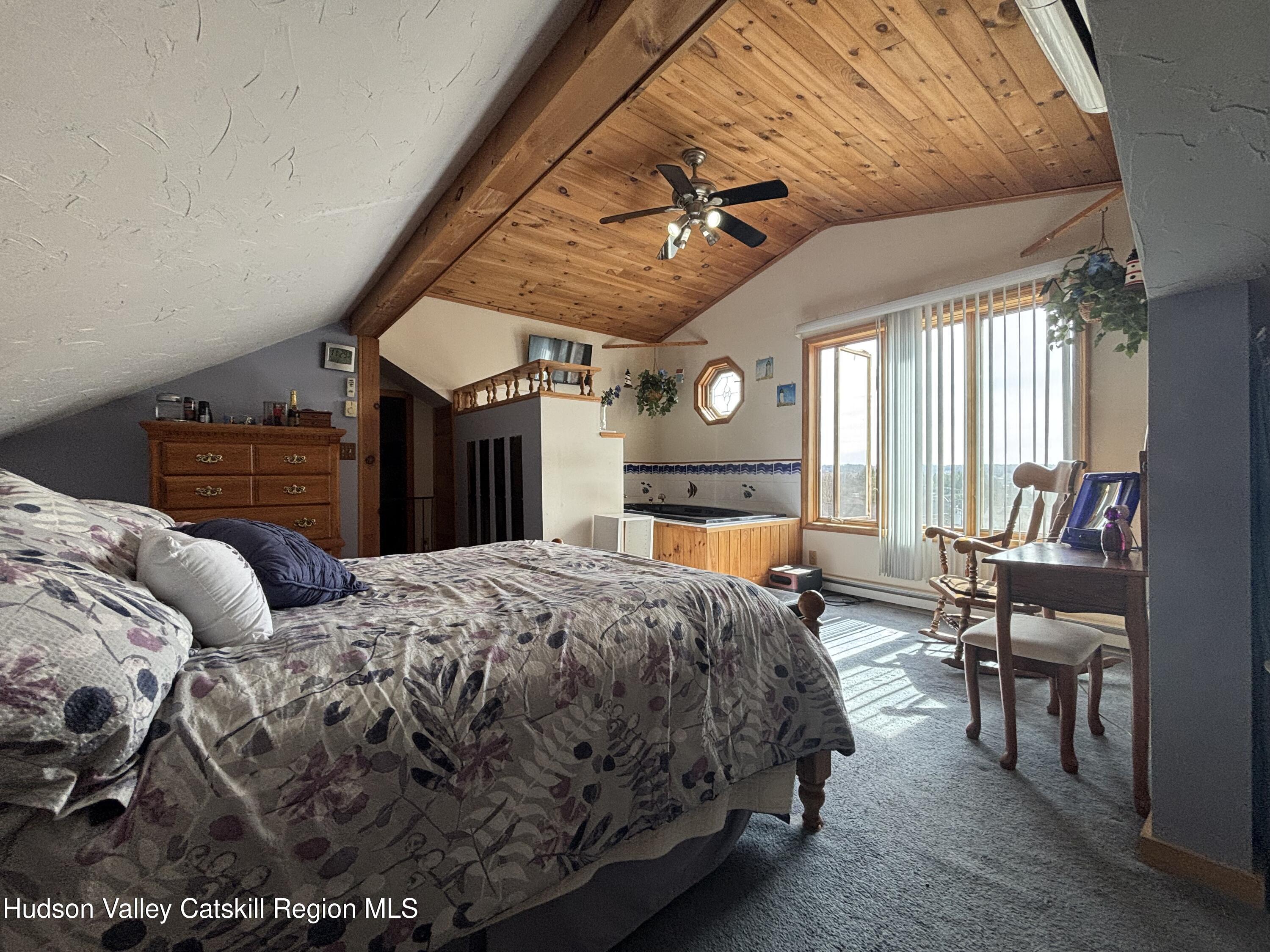 6 Maple Street Catskill, NY 12414 - Photo 16 of 20 a bedroom with a bed and a chandelier