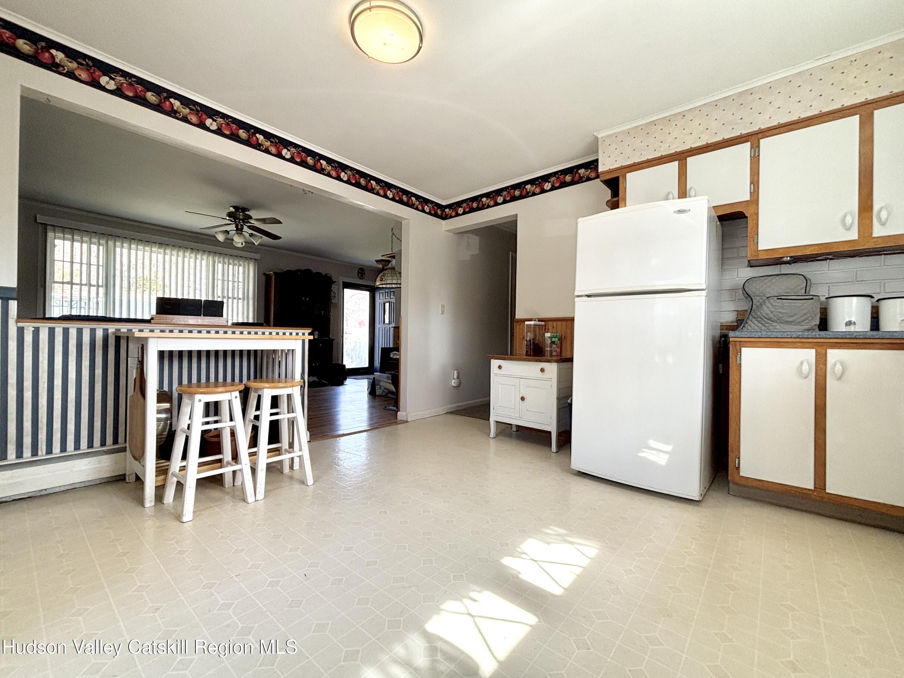 6 Maple Street Catskill, NY 12414 - Photo 5 of 20 a view of a kitchen with furniture and a refrigerator