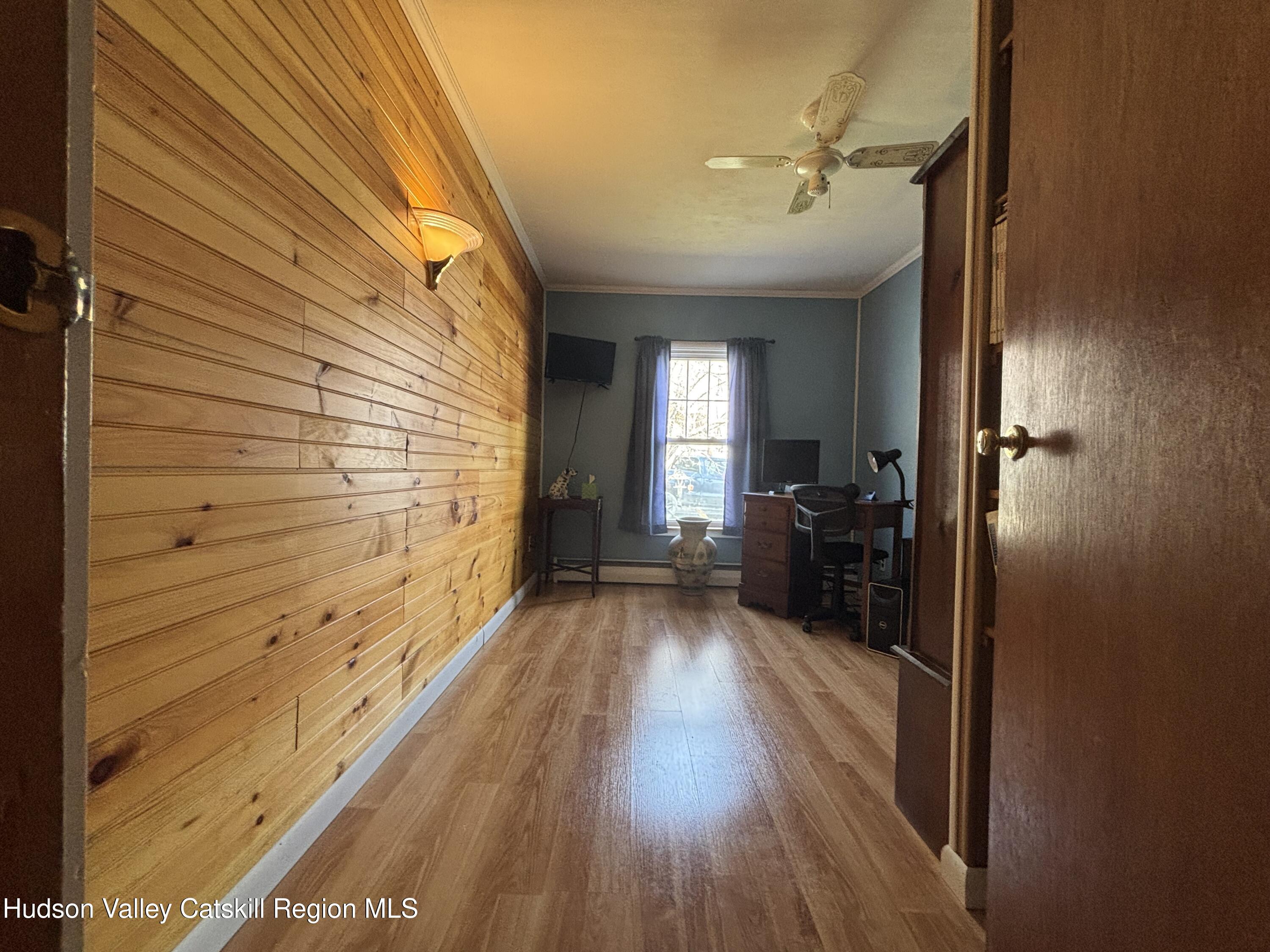 6 Maple Street Catskill, NY 12414 - Photo 9 of 20 a view of a hallway with wooden floor and staircase
