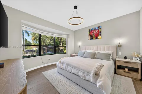 a bedroom with a bed and a flat screen tv