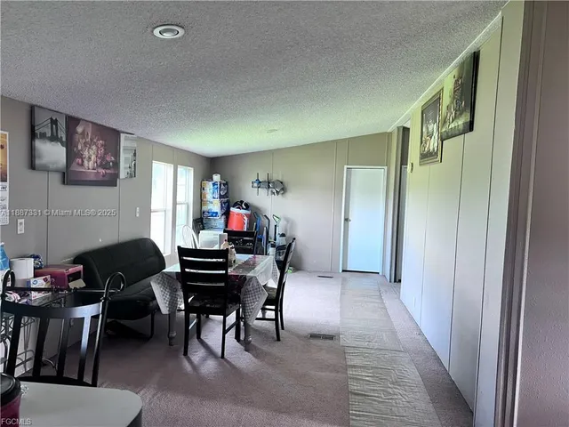 a view of a livingroom with furniture and white walls