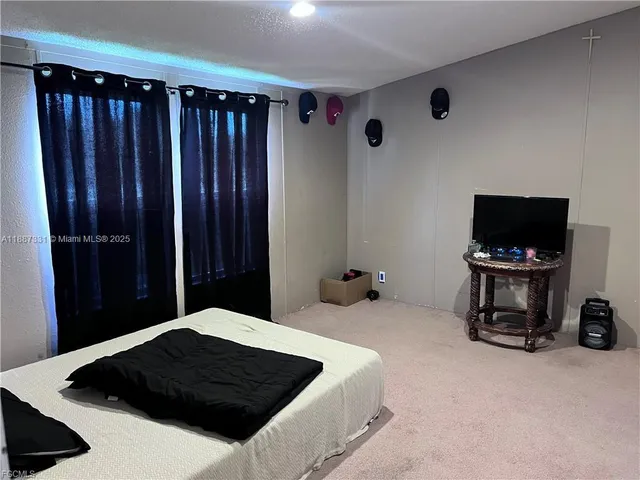 a bedroom with a bed and a television