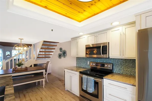 a kitchen with stainless steel appliances a stove a microwave and wooden cabinets