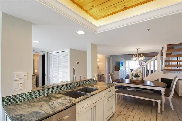 a kitchen with a sink and living room view