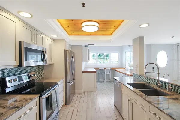 a kitchen with a sink stove and refrigerator