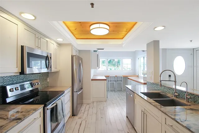 a kitchen with a sink stove and refrigerator