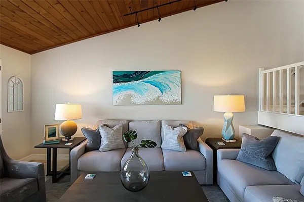 a living room with furniture and a lamp