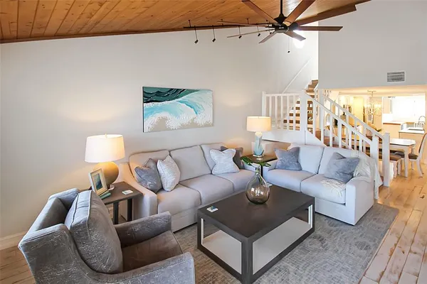 a living room with furniture and a lamp