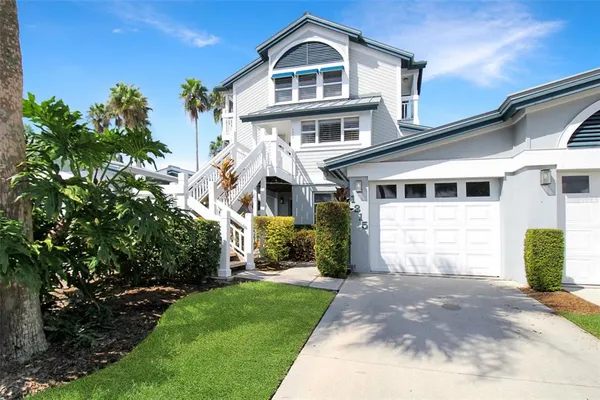 a front view of a house with a garden and plants