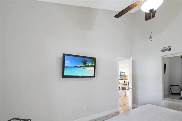 a bedroom with a bed and a wall painting