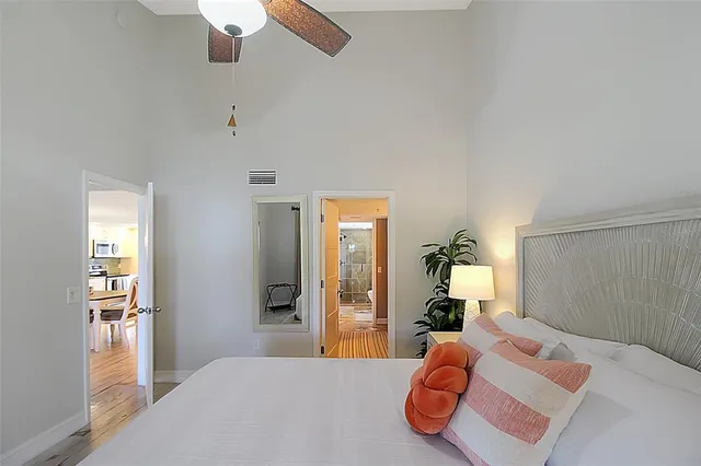 a bedroom with a bed and a chandelier