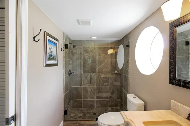 a bathroom with a toilet and a mirror