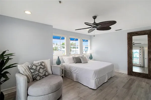 a bedroom with a bed couch and window