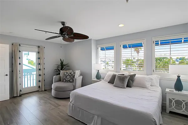 a bedroom with a bed and a large window