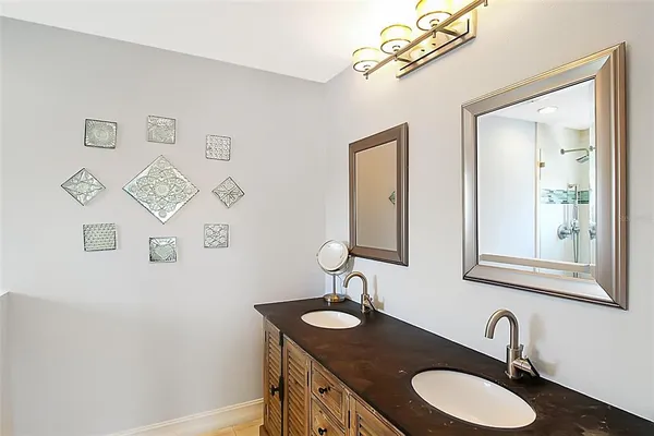 a bathroom with a granite countertop sink and a mirror