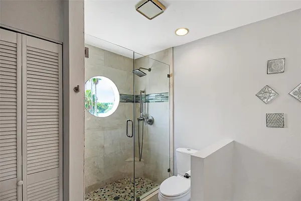a bathroom with a toilet and a shower