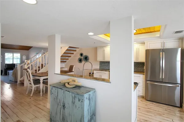 a kitchen with stainless steel appliances granite countertop a refrigerator and a stove top oven