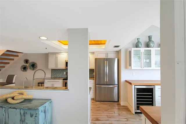 a kitchen with stainless steel appliances a sink cabinets and wooden floor